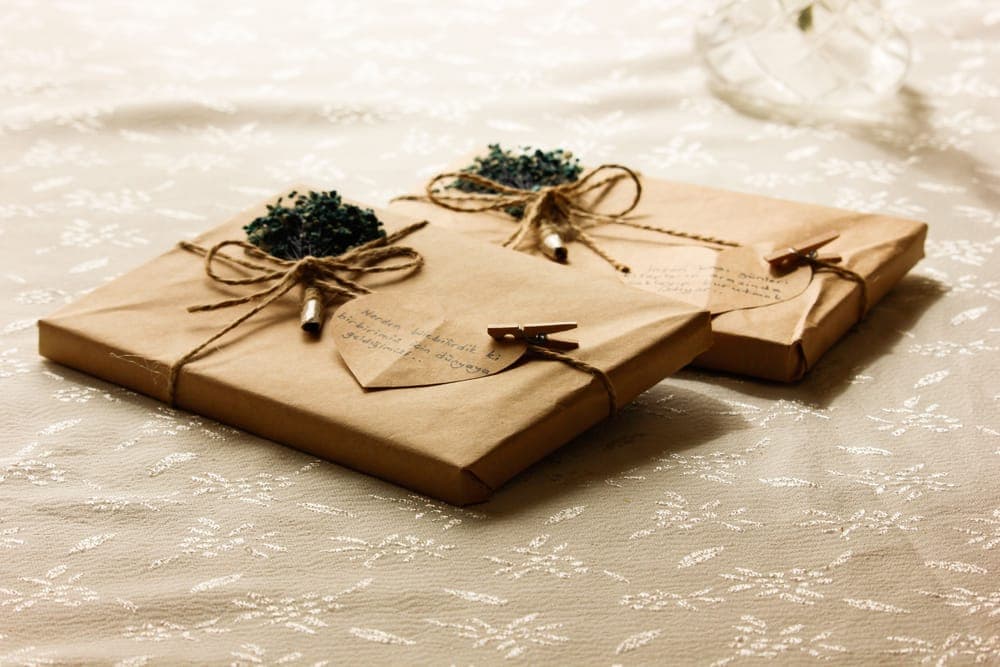 Two gifts wrapped in kraft paper and twine with paper-heart tags
